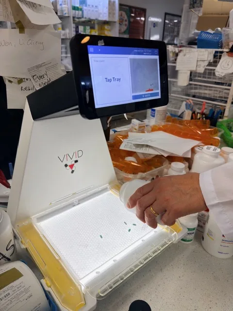 Automated pill-counting machine preparing a prescription at Patient Care Pharmacy