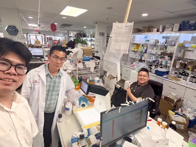 Pharmacy team members working together behind the counter
